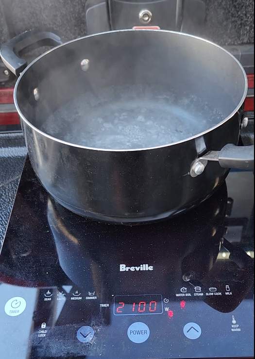 Water boiling in pot on induction cooktop